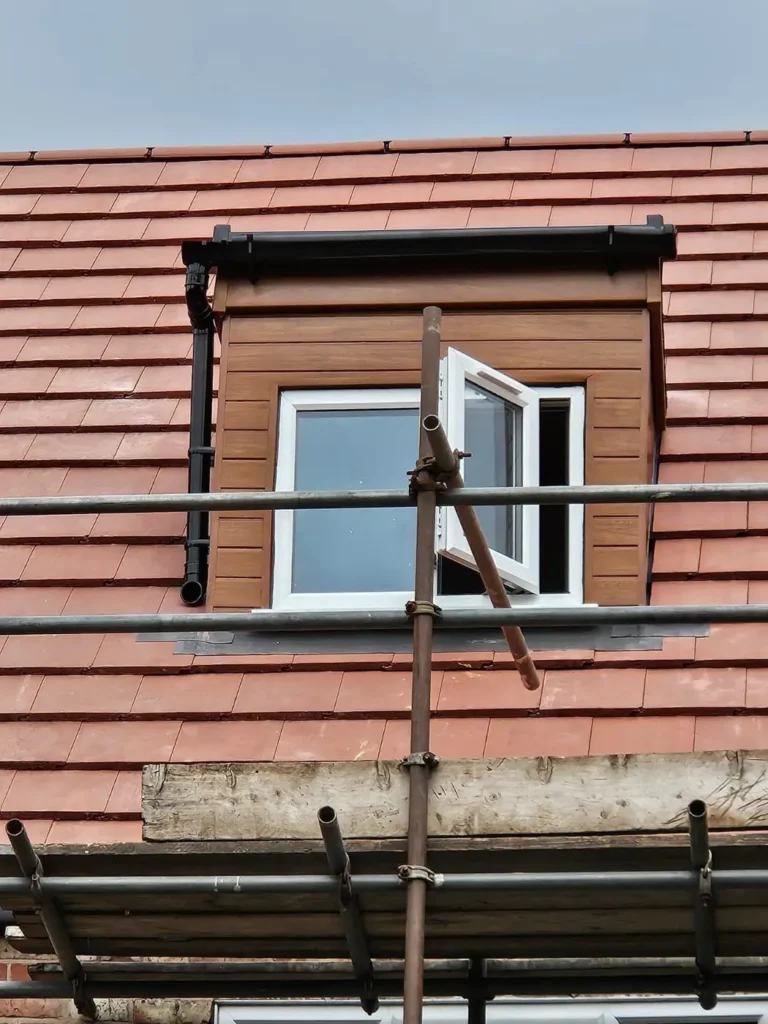 Dormer window with new red roof tiles
