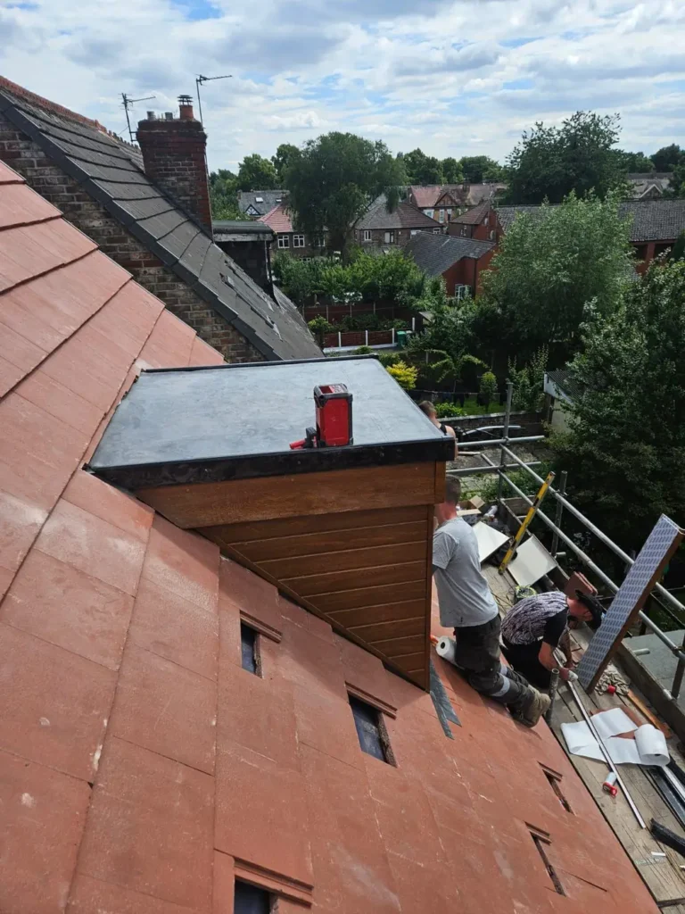 Dormer with lead roof and new red tiles