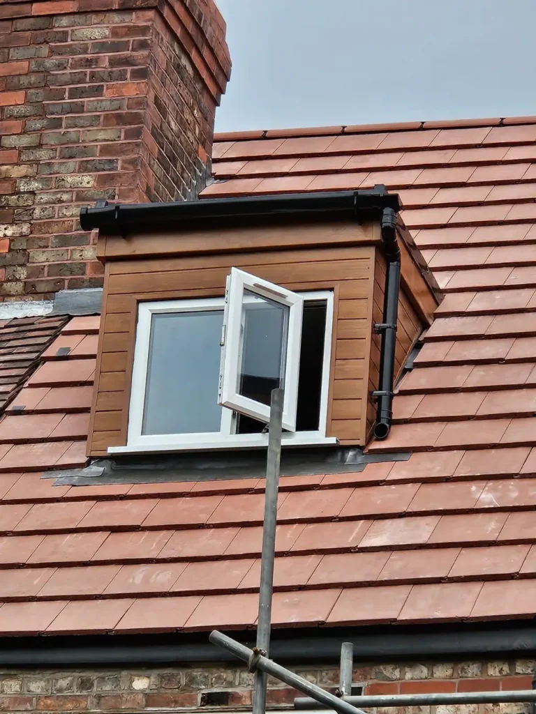 Dormer window and chimney with new roof tiles