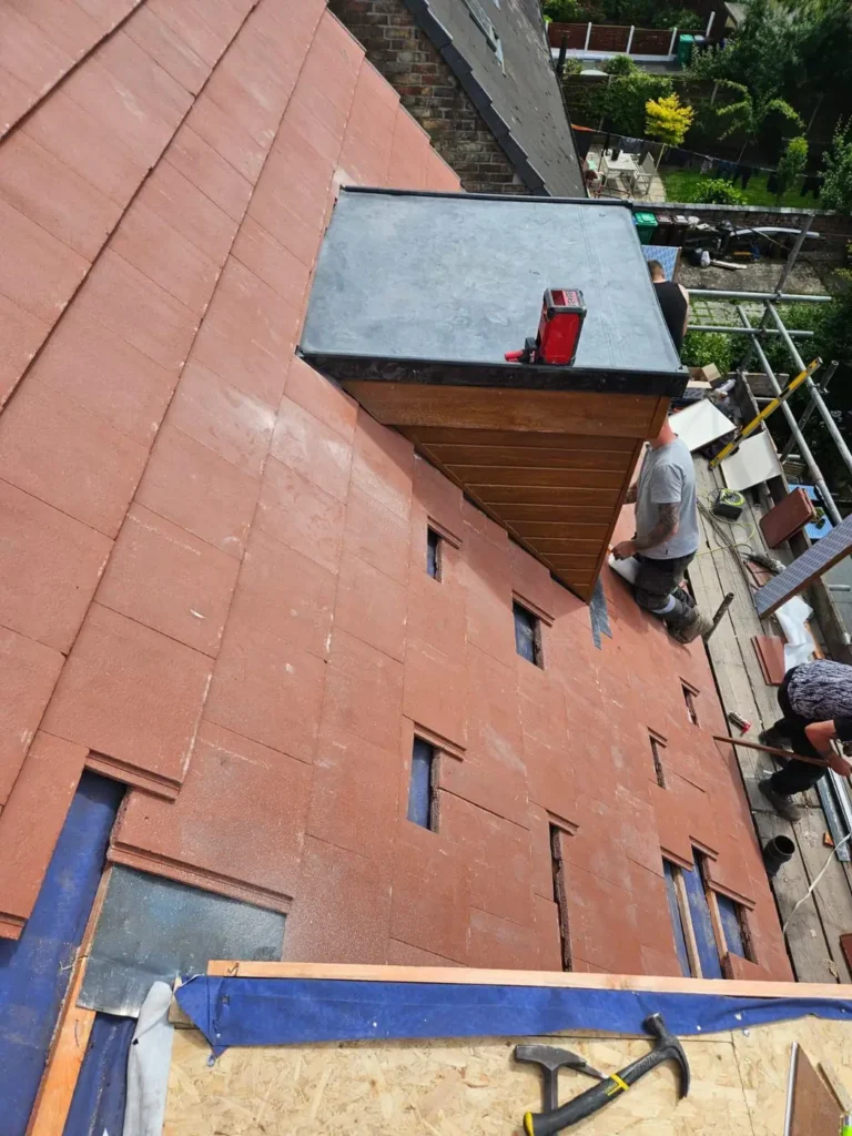 New tiles around a dormer with lead roof