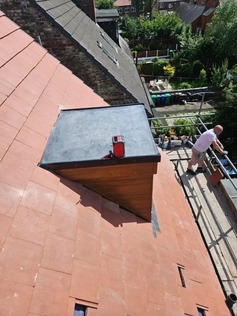Dormer roof with lead covering and new tiles