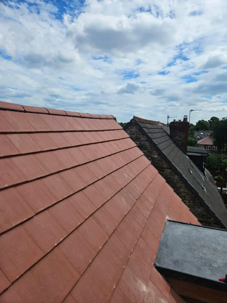 New red roof tiles beside a dormer