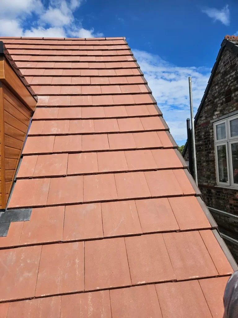 New roof tiles beside a timber-clad dormer