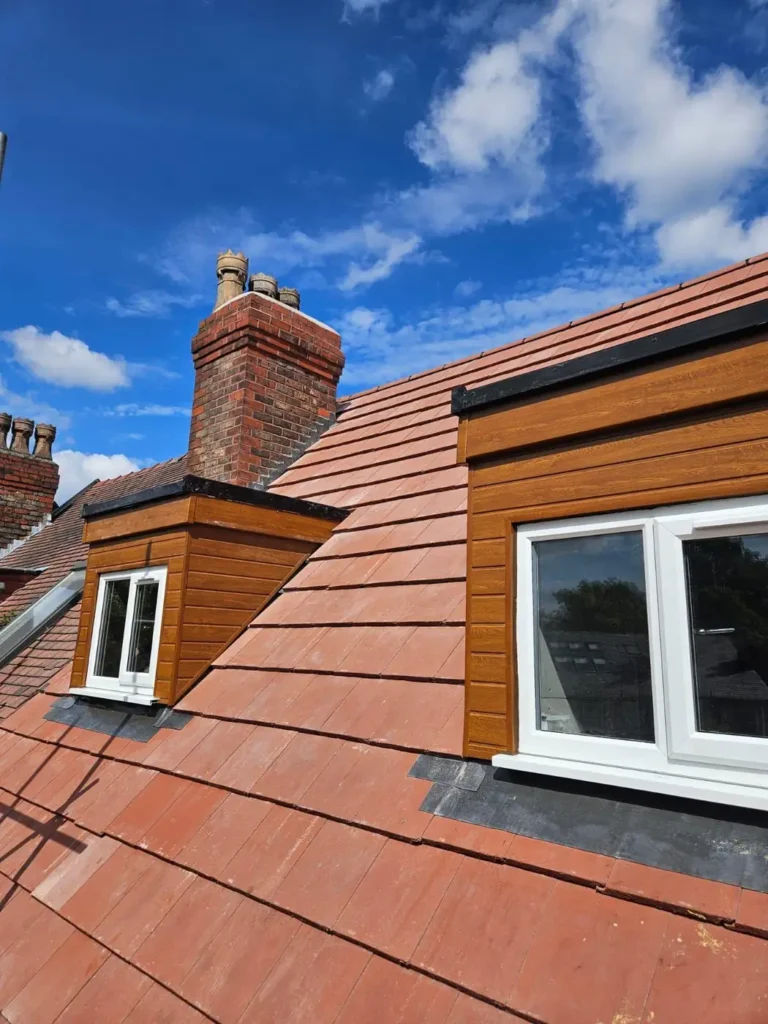 Dormer windows with a new red tiled roof