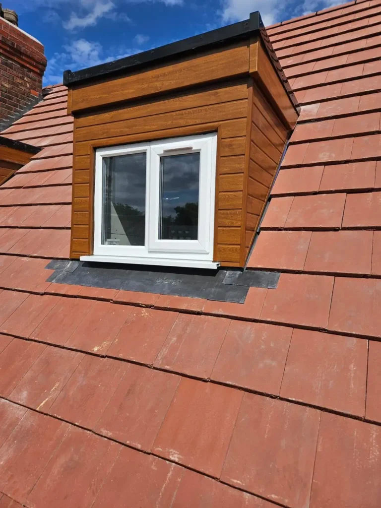Dormer with white window and new tiles