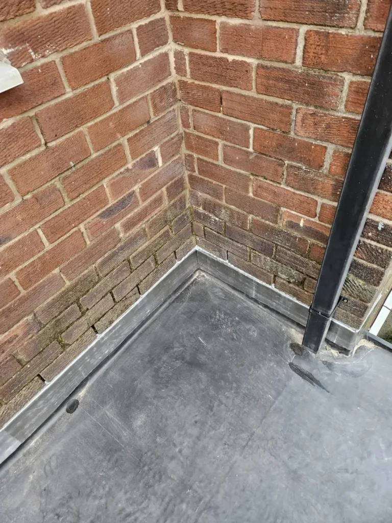 Flat roof corner detail with upstand