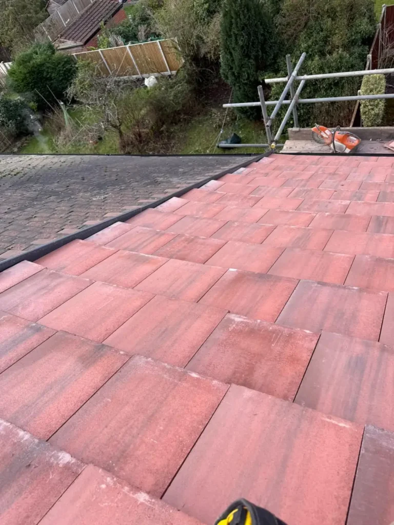 New red roof tiles laid on a roof slope