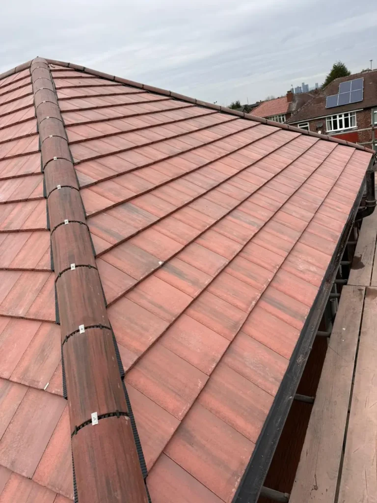 New hip roof with ridge tiles completed