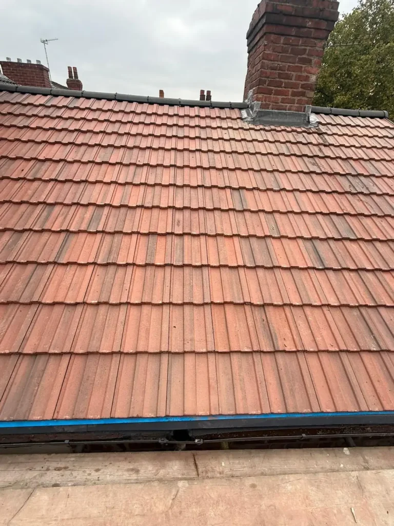 New roof tiles with chimney flashing detail