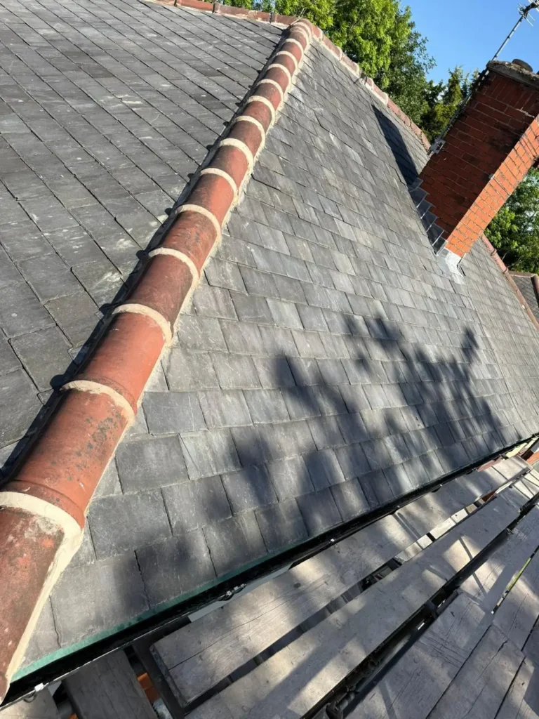 Slate roof with new ridge tiles