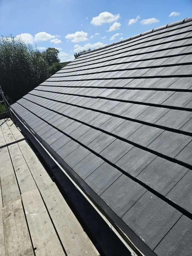 New dark grey roof tiles with verge detail
