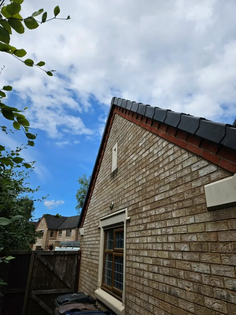 New tiled roof on a brick house with black ridge tiles