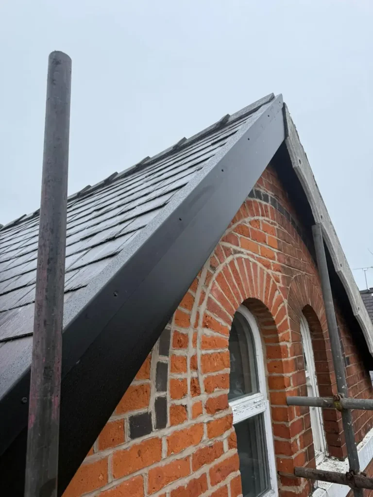 Black fascia on a brick gable with an arched window