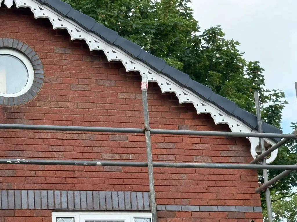 Decorative scalloped bargeboard on a brick gable