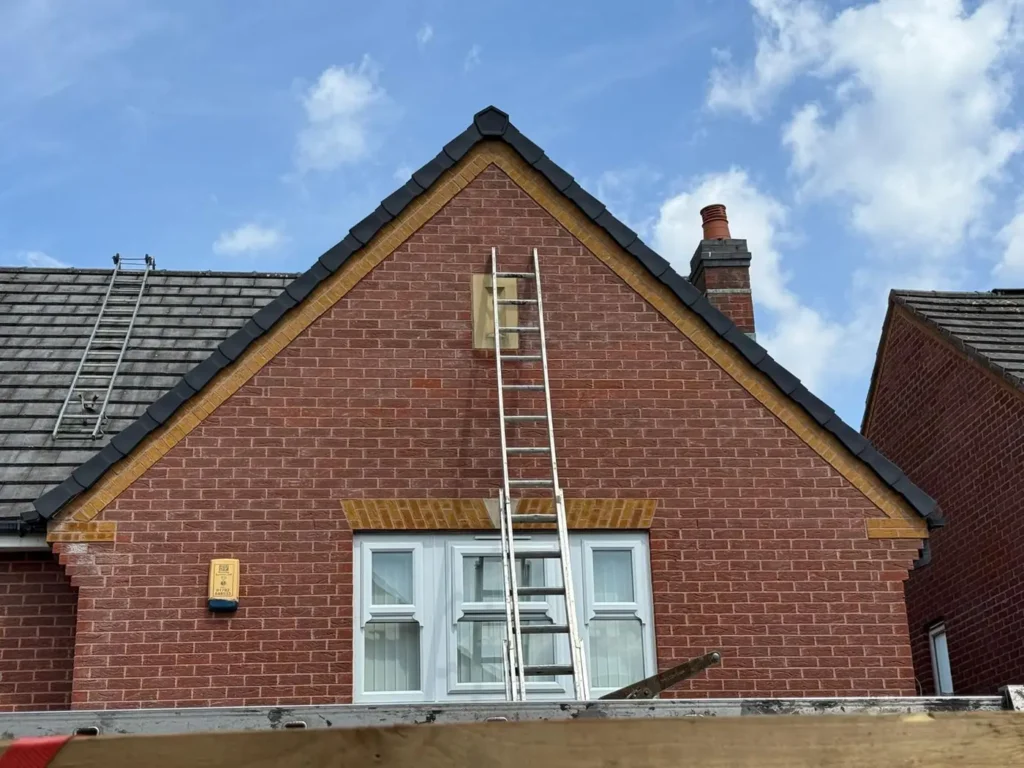 Brick gable end with new black fascia